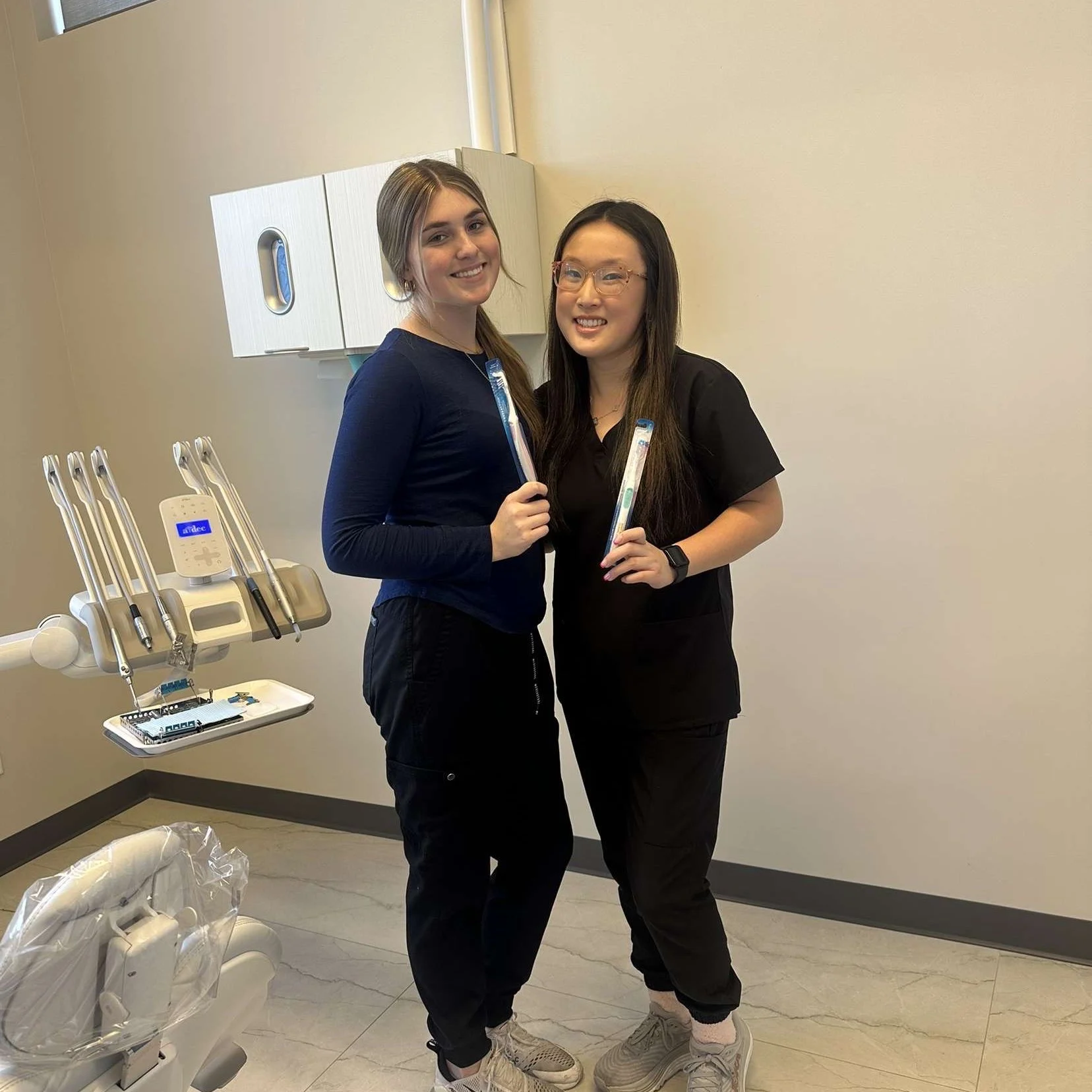 two young ladies in uniform at dental office